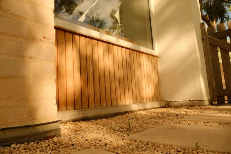 Timber cladding detail on rammed earth wall